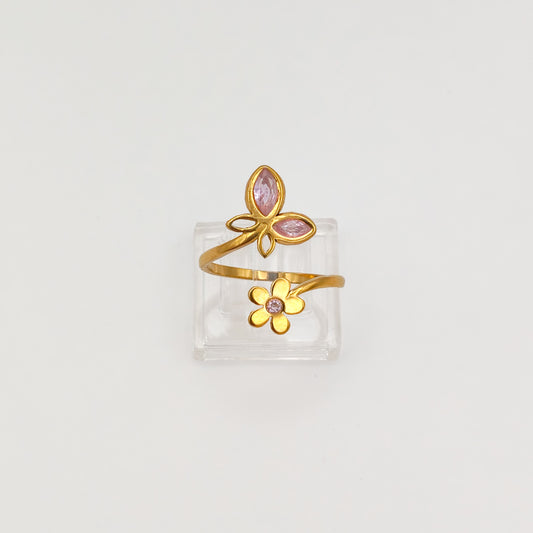 Packshot of an adjustable gold plated butterfly and flower cubic zirconia ring, waterproof and tarnish resistant