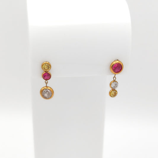 Front view of gold-plated stainless steel drop earrings featuring bezel-set round pink, yellow, and clear CZ gems on a white stand.
