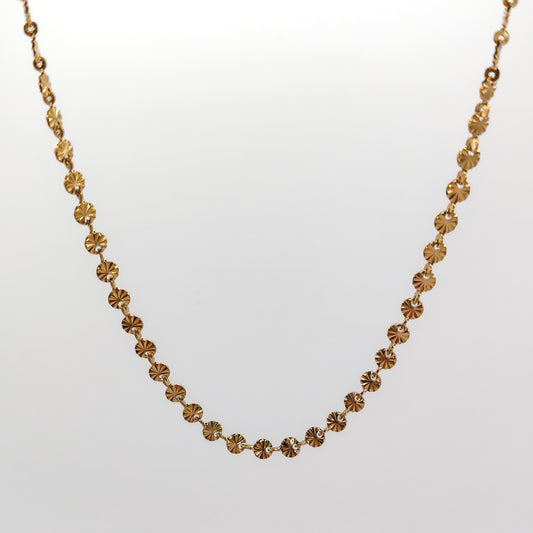 A close-up view of the gold-plated chain, showcasing the intricate diamond-cut ridges radiating from the center of each 4mm disc link.