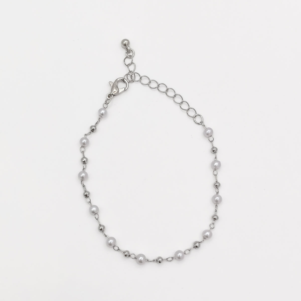 Full view of a silver-plated pearl beaded bracelet showing its lobster clasp and adjustable extender chain.