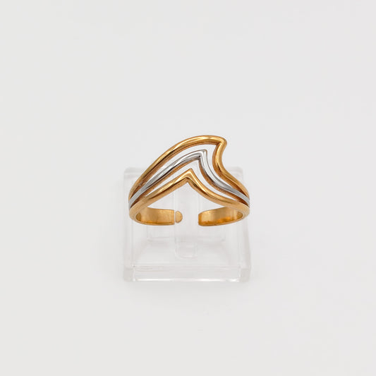 Front view of the gold and silver layered chevron wave ring on a clear acrylic stand, showcasing the open-back adjustable band.