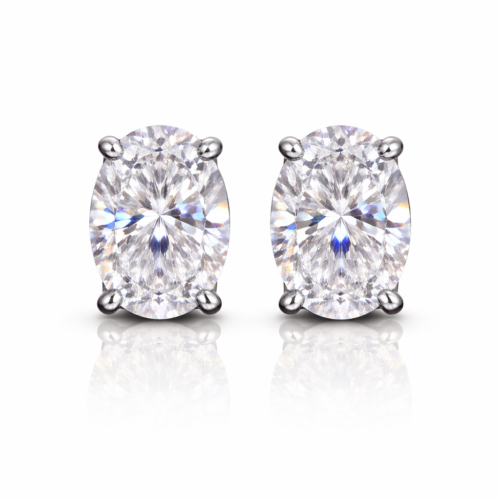 Pair of silver-plated earrings with clear oval cubic zirconia's on a white background