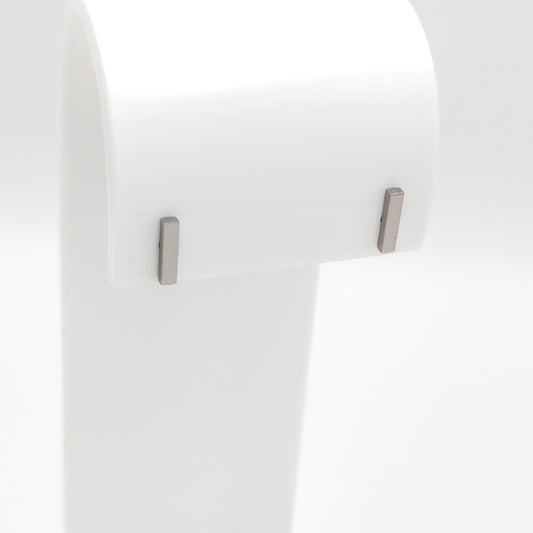 Detailed close-up of a pair of silver-plated stainless steel minimalist vertical bar stud earrings with a sleek geometric profile, displayed on a white stand.