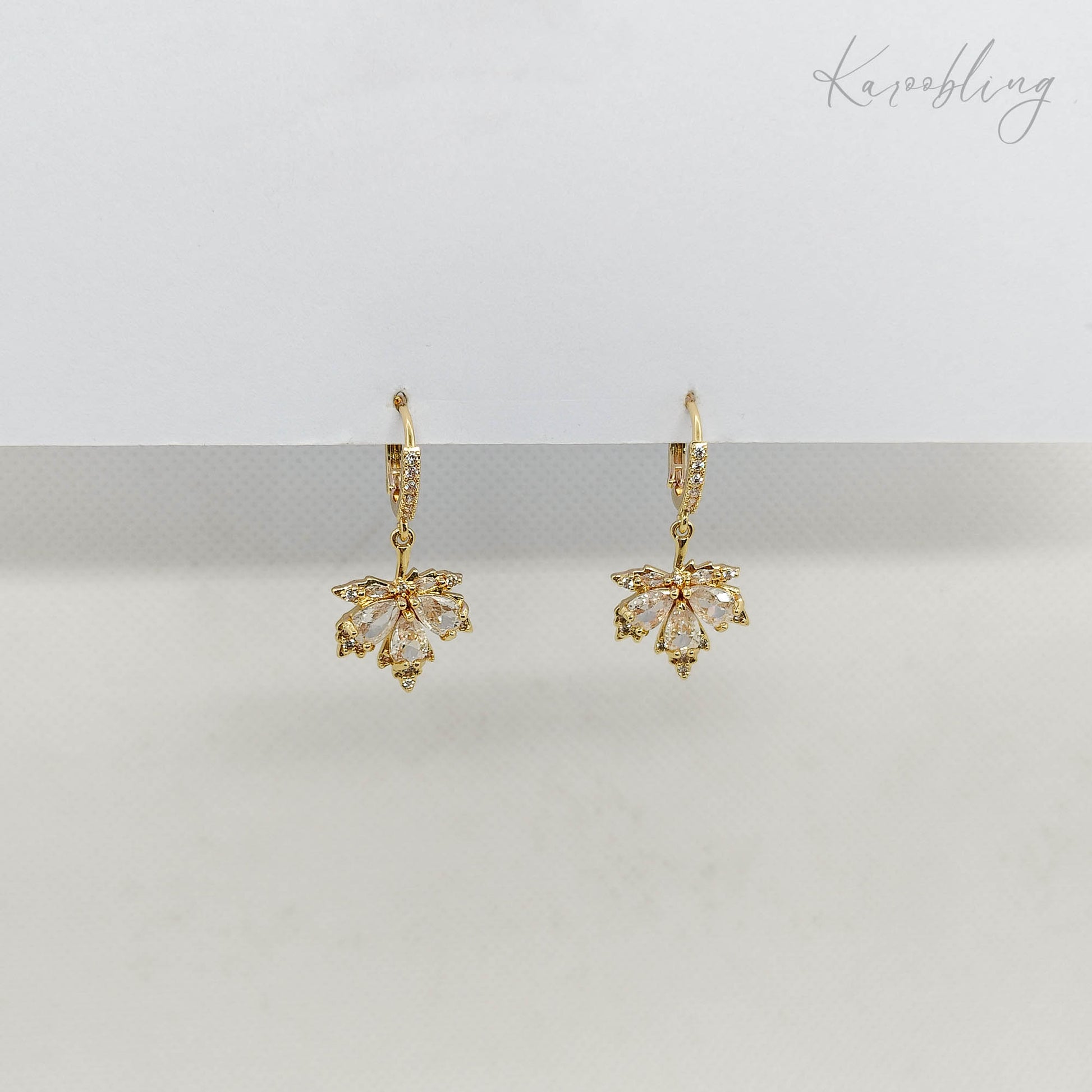 Clear CZ Maple Leaves Huggie Earrings - side angle