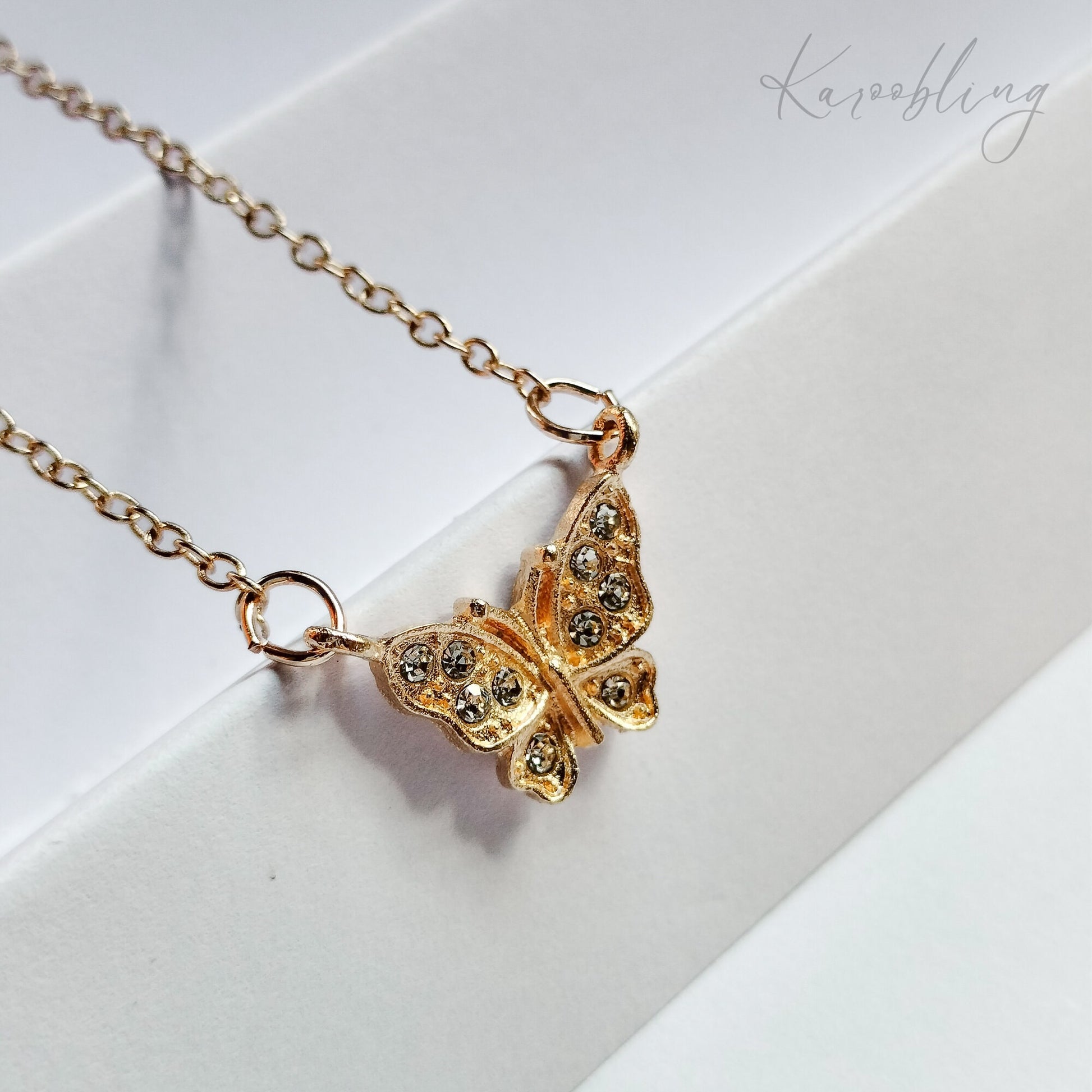 Gold FlutterGlow Butterfly Necklace - close up