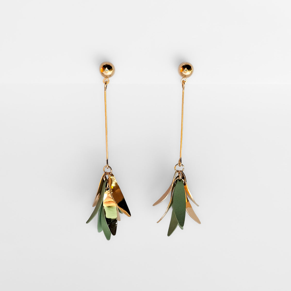 sage & gold plated dangle earrings hanging on a white display stand