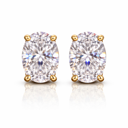 Pair of gold-plated earrings with clear oval cubic zirconia's on a white background