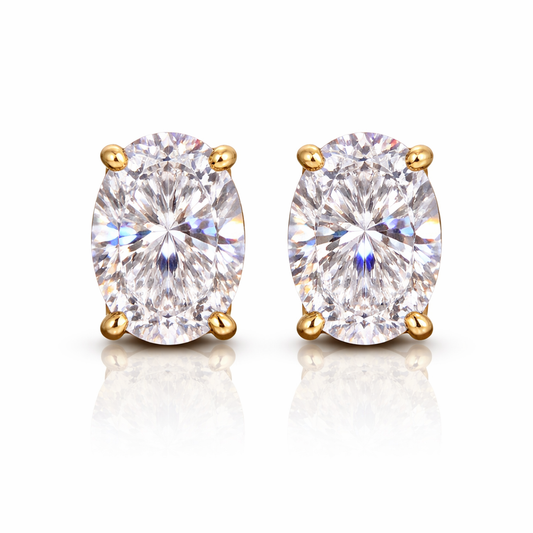 Pair of gold-plated earrings with clear oval cubic zirconia's on a white background