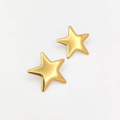 A pair of gold star-shaped stud earrings on a clean white background.