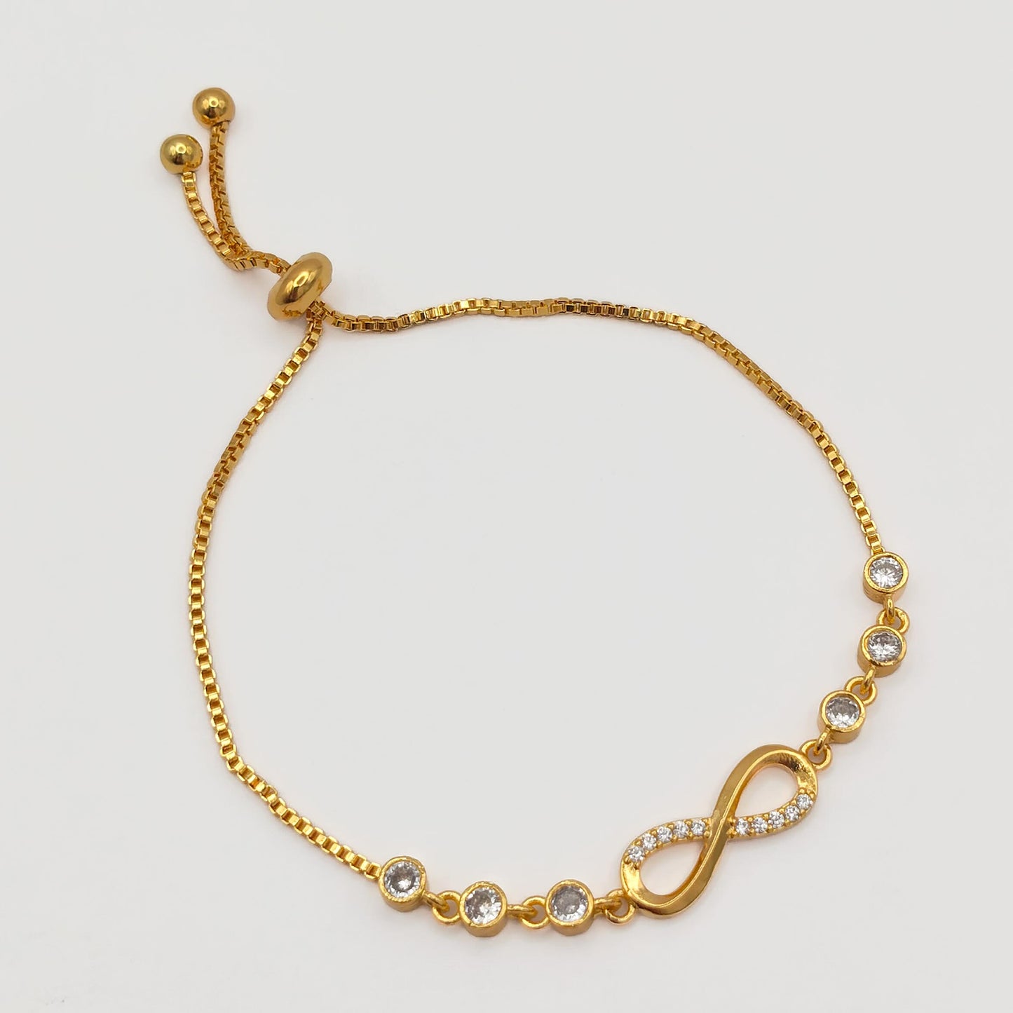 packshot of a fashion jewellery, gold plated cz pull-cord bracelet 