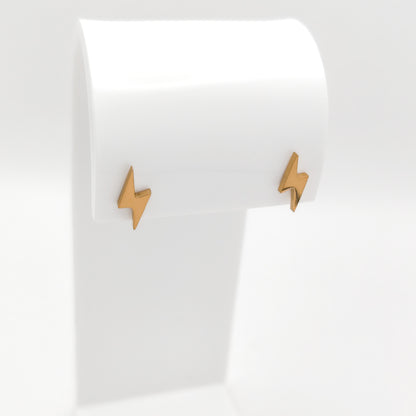 Side-angle view of gold-plated stainless steel lightning bolt post earrings showcasing their sleek geometric silhouette and bright luster.