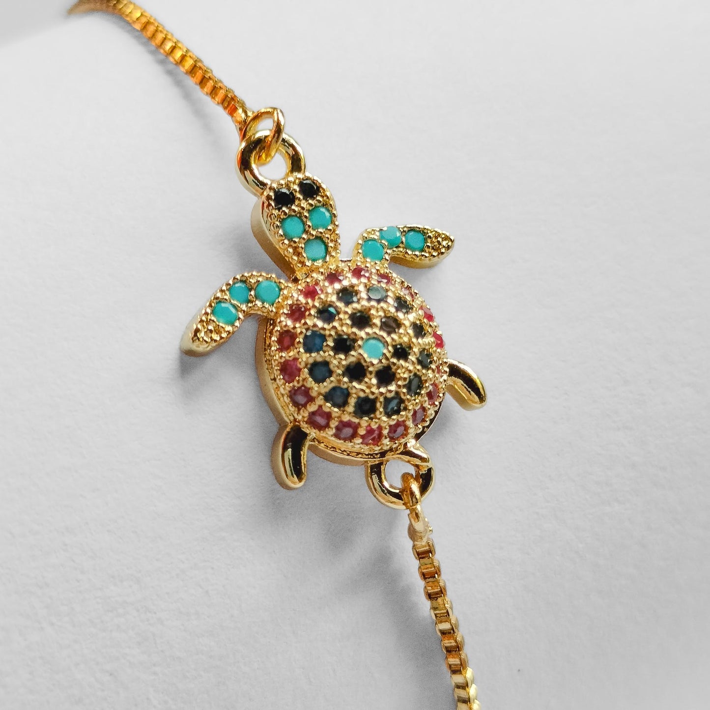 packshot of a gold plated sea turtle fashion jewellery bracelet