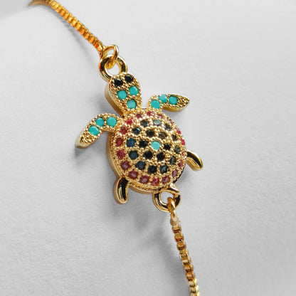 packshot of a gold plated sea turtle fashion jewellery bracelet
