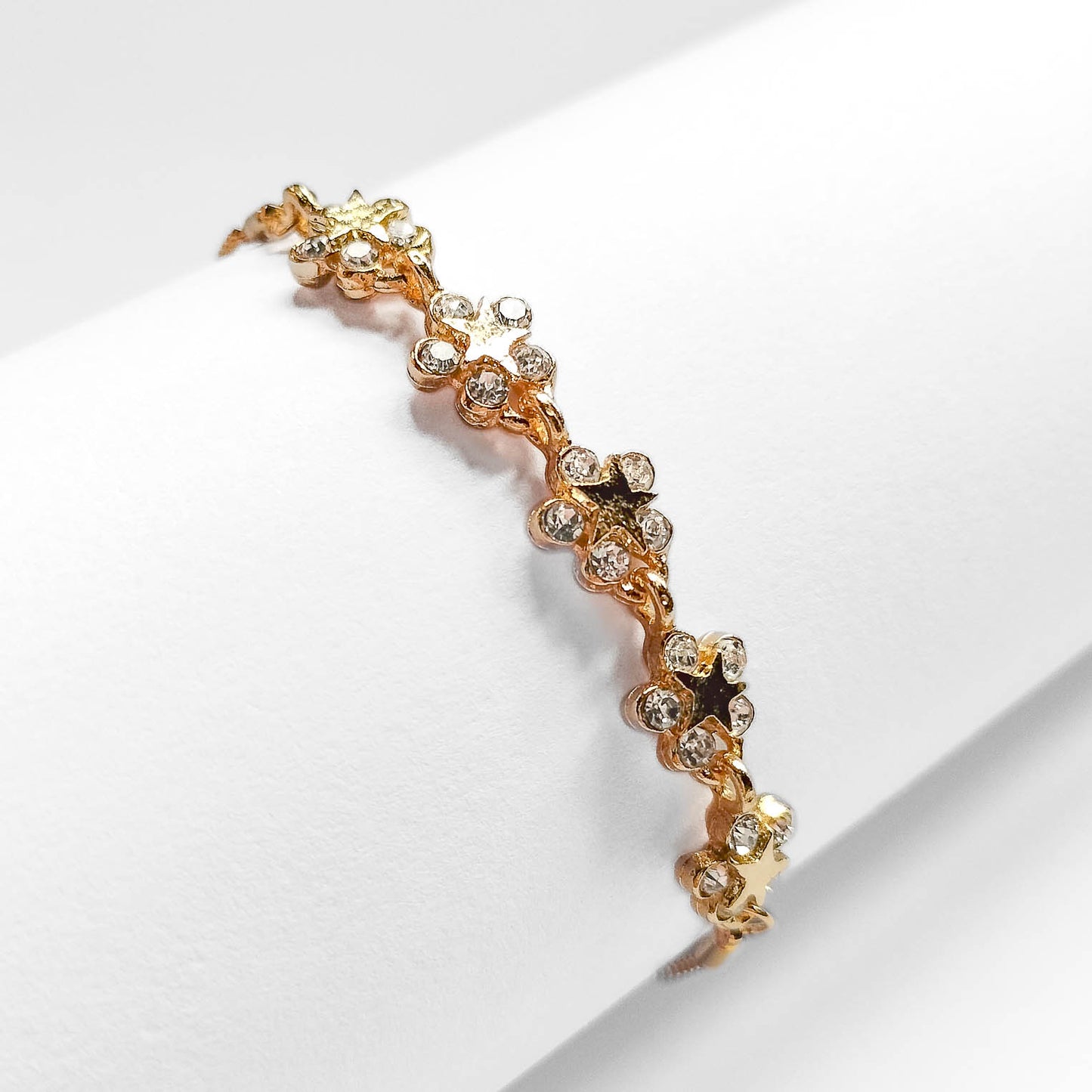 packshot of a fashion jewellery gold plated star flower bracelet