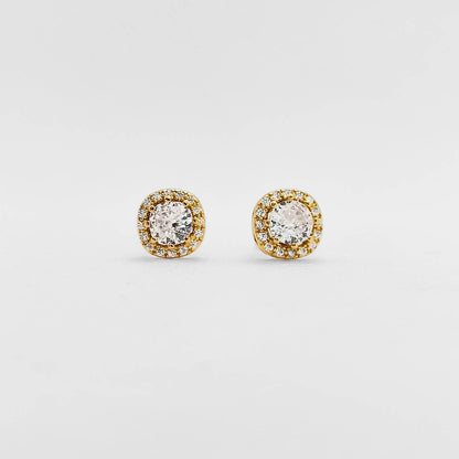 A pair of round stud earrings with clear central stones surrounded by a halo of small yellow gold stones on a plain light gray background.