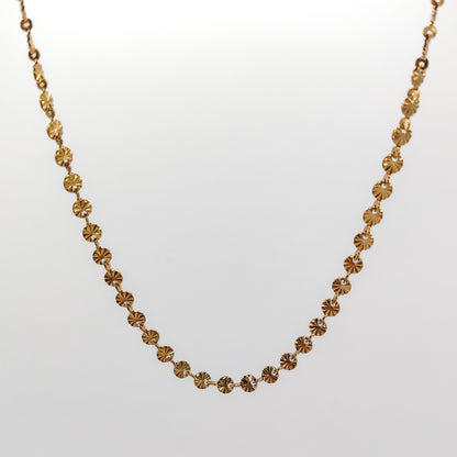 A close-up view of the gold-plated chain, showcasing the intricate diamond-cut ridges radiating from the center of each 4mm disc link.