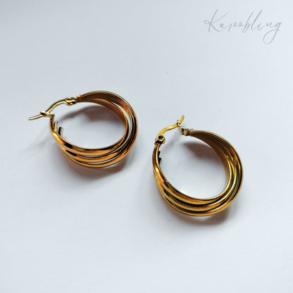 packshot of gold plated triple twisted hoop earrings that is waterproof and tarnish resistant