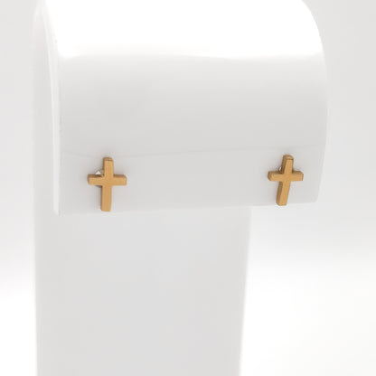 Close-up of gold-plated cross stud earrings showing the simple cross design.