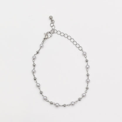 Full view of a silver-plated pearl beaded bracelet showing its lobster clasp and adjustable extender chain.