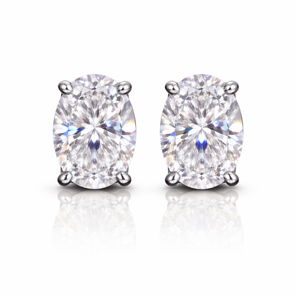 Pair of silver-plated earrings with clear oval cubic zirconia's on a white background
