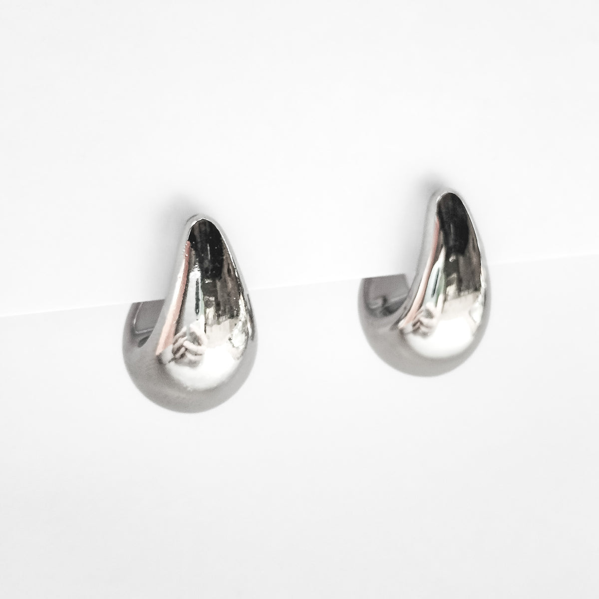 silver plated chunky teardrop stud earrings on a white display