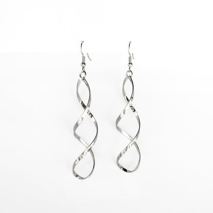 silver plated spiral dangle earrings on a white display stand