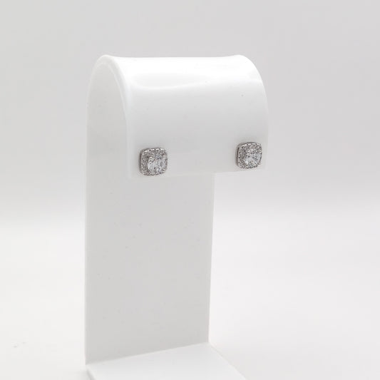 A pair of square stud earrings with clear gemstones in a silver-toned setting, displayed on a white jewelry stand against a light gray background.
